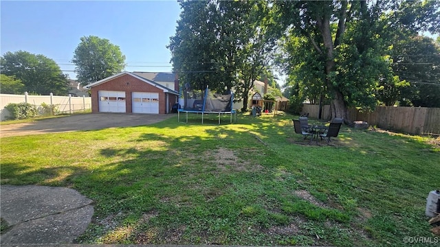 7360 Ford Ave, Mechanicsville, VA 23111 - fenced backyard featuring a trampoline, an outdoor structure, a garage, and a playground