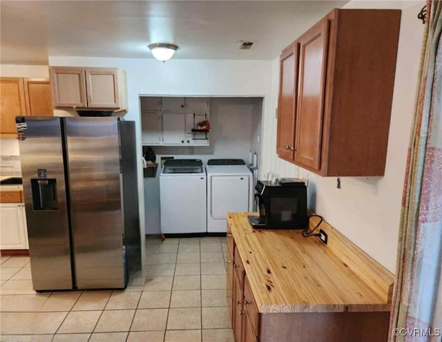 5724 Linda Rd, Sandston, VA 23150 - kitchen featuring stainless steel refrigerator with ice dispenser, separate washer and dryer, black microwave, butcher block counters, and light tile patterned floors