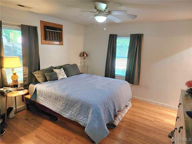 5724 Linda Rd, Sandston, VA 23150 - bedroom with light wood-style floors, an AC wall unit, and ceiling fan