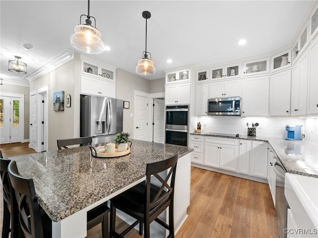 1270 Mill Quarter Rd, Powhatan, VA 23139 - kitchen with appliances with stainless steel finishes, recessed lighting, ornamental molding, a breakfast bar area, and decorative light fixtures