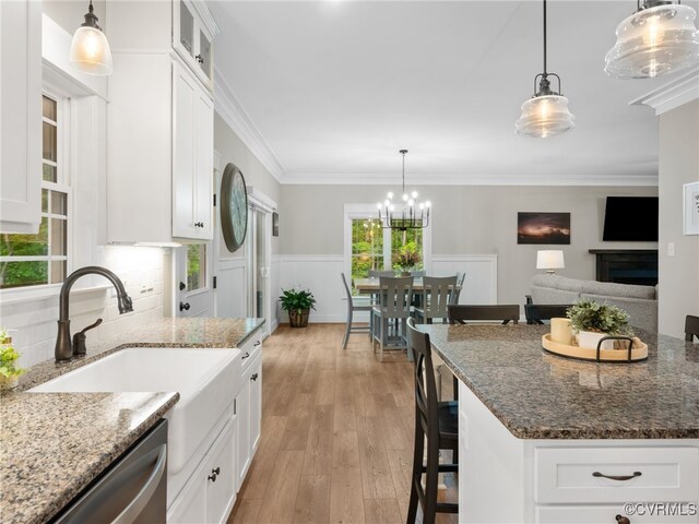 1270 Mill Quarter Rd, Powhatan, VA 23139 - kitchen with dishwasher, white cabinetry, light wood-type flooring, dark stone countertops, and ornamental molding