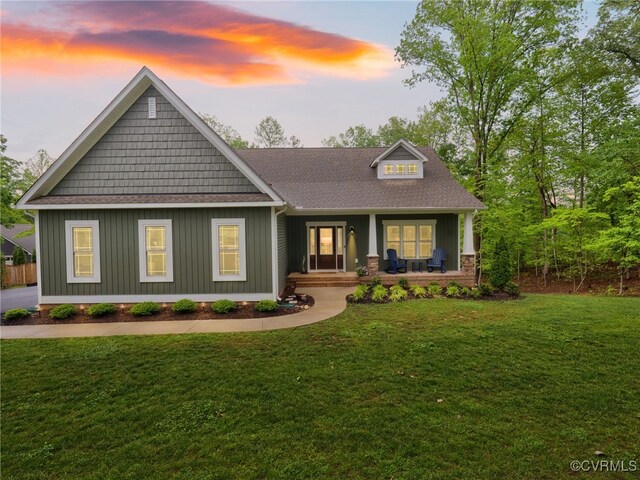 1270 Mill Quarter Rd, Powhatan, VA 23139 - craftsman house featuring a porch, a front lawn, roof with shingles, and board and batten siding