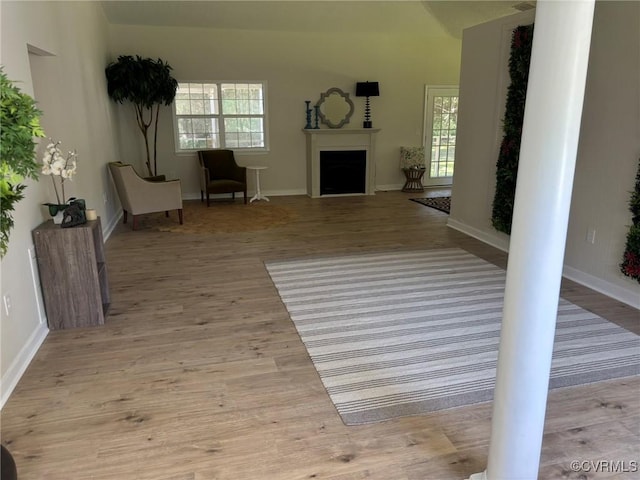 111 New S Rd, Lancaster, VA 22482 - unfurnished living room featuring ornate columns, healthy amount of natural light, and wood finished floors