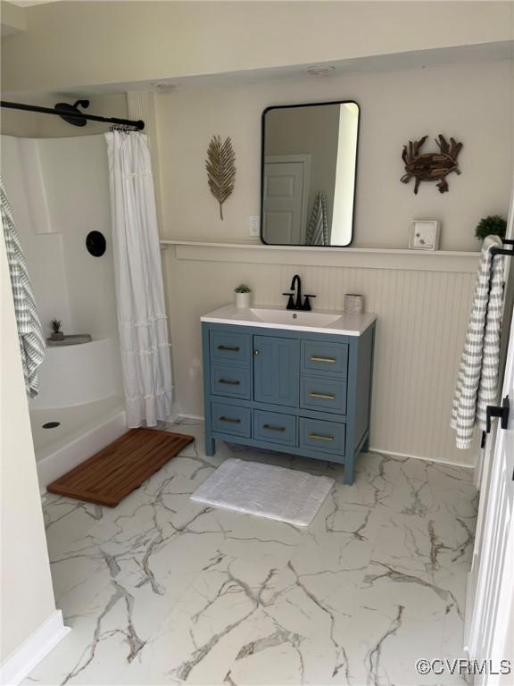 111 New S Rd, Lancaster, VA 22482 - full bathroom with marble look tiles, vanity, and wainscoting
