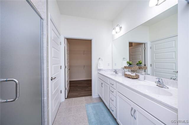 10698 Skippers St, Glen Allen, VA 23059 - full bathroom featuring double vanity, a stall shower, tile patterned flooring, and a walk in closet