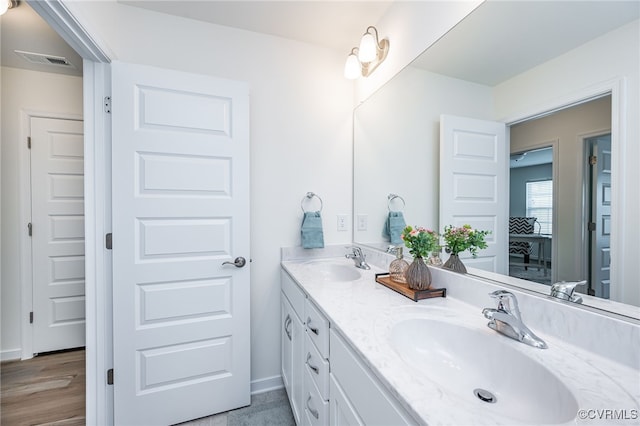 10698 Skippers St, Glen Allen, VA 23059 - full bathroom featuring double vanity and wood finished floors