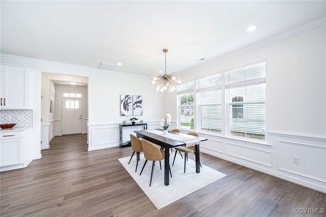 10698 Skippers St, Glen Allen, VA 23059 - dining space with a chandelier, plenty of natural light, ornamental molding, a decorative wall, and light wood-type flooring