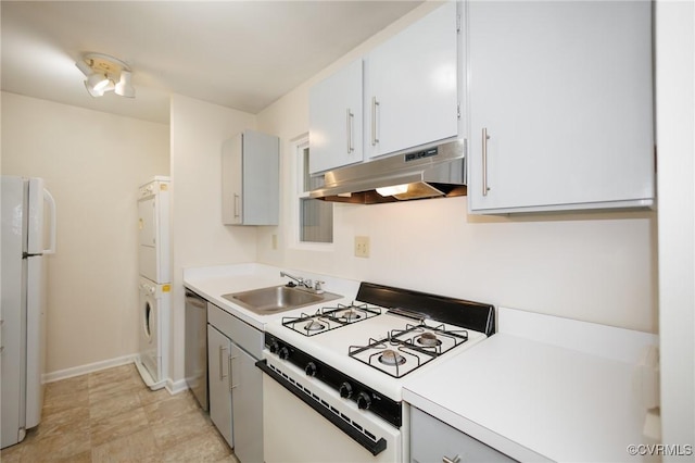 11808 N Briar Patch Dr, Midlothian, VA 22313 - kitchen featuring white appliances, estacked washer and dryer, under cabinet range hood, and light countertops