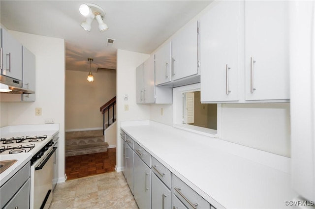 11808 N Briar Patch Dr, Midlothian, VA 22313 - kitchen with white gas range oven, range hood, light countertops, and gray cabinetry