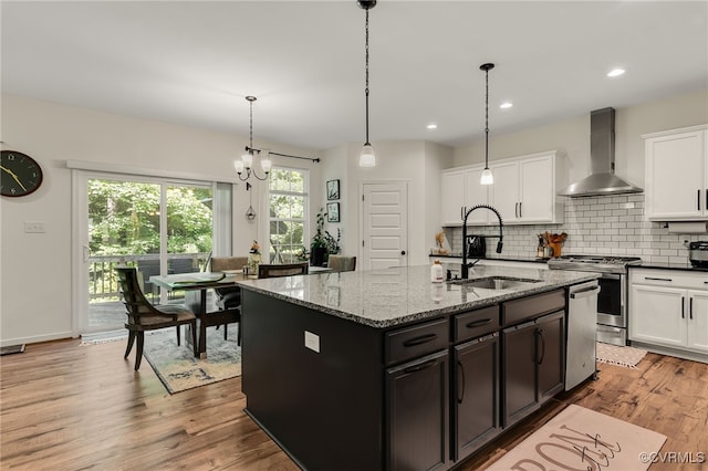 6112 Water Violet Ter, Moseley, VA 23120 - kitchen featuring wall chimney exhaust hood, appliances with stainless steel finishes, light wood finished floors, white cabinets, and recessed lighting