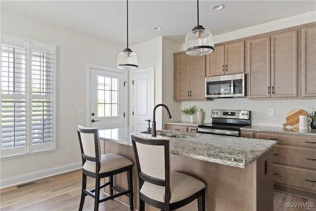 109 Axton Ln, Ashland, VA 23005 - kitchen featuring appliances with stainless steel finishes, light wood-style flooring, light stone countertops, hanging light fixtures, and recessed lighting