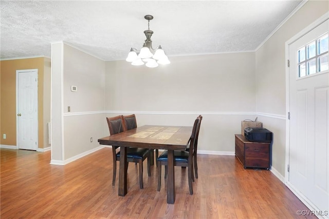 291 Briery Hills Dr, Meherrin, VA 23954 - dining space featuring a chandelier, light wood-type flooring, a textured ceiling, and ornamental molding