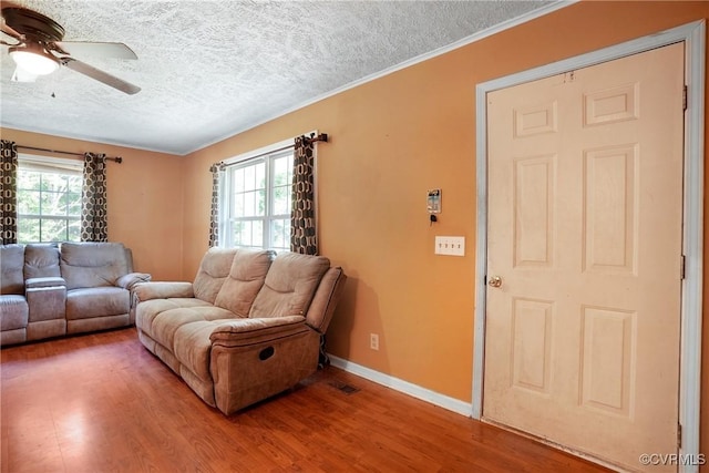 291 Briery Hills Dr, Meherrin, VA 23954 - living room featuring wood finished floors, ceiling fan, a textured ceiling, and crown molding