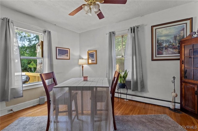 306 Hamilton Ave, Colonial Heights, VA 23834 - dining room featuring baseboard heating, plenty of natural light, ceiling fan, and wood finished floors