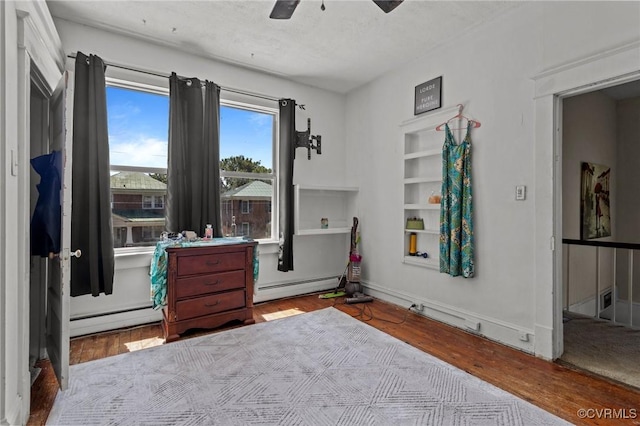 306 Hamilton Ave, Colonial Heights, VA 23834 - bedroom with a baseboard heating unit, a baseboard radiator, wood finished floors, and a ceiling fan