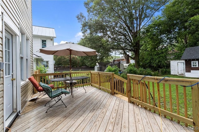 306 Hamilton Ave, Colonial Heights, VA 23834 - wooden terrace featuring outdoor dining area, a storage unit, and a lawn