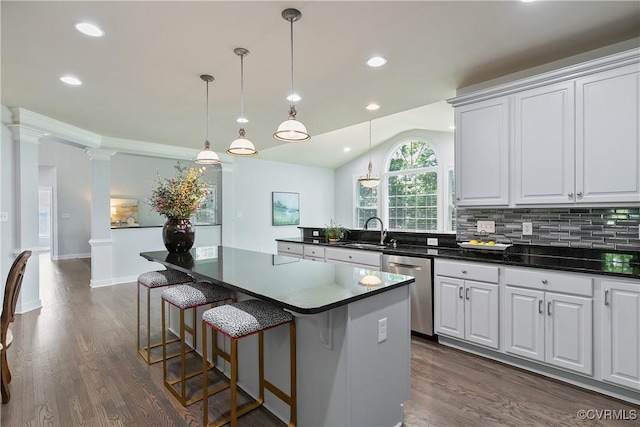 6430 Arwen Mews, Moseley, VA 23120 - kitchen featuring stainless steel dishwasher, dark countertops, a kitchen island, dark wood finished floors, and white cabinets
