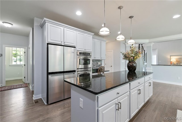 6430 Arwen Mews, Moseley, VA 23120 - kitchen with stainless steel appliances, dark wood finished floors, white cabinetry, a kitchen island, and recessed lighting