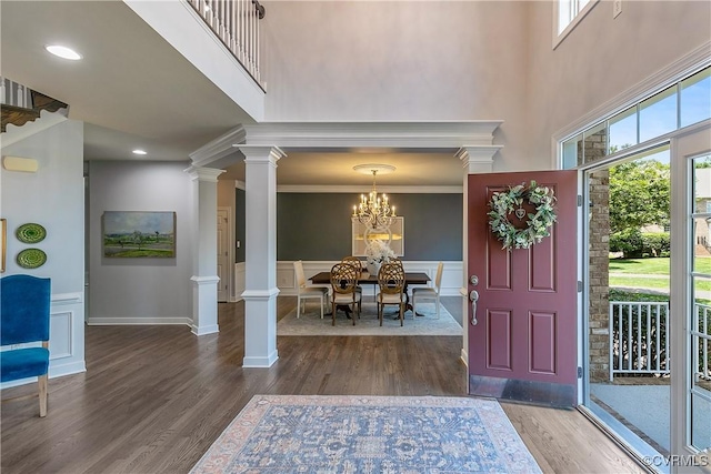 6430 Arwen Mews, Moseley, VA 23120 - foyer entrance with ornate columns, a towering ceiling, wood finished floors, a chandelier, and a wainscoted wall