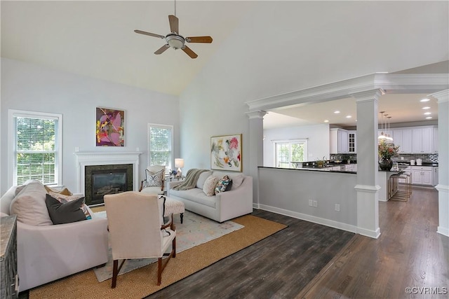 6430 Arwen Mews, Moseley, VA 23120 - living room with decorative columns, ceiling fan, a glass covered fireplace, dark wood-style flooring, and high vaulted ceiling