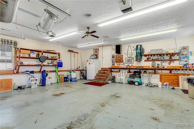 716 W Riverside Dr, Lanexa, VA 23089 - garage featuring a workshop area, a garage door opener, freestanding refrigerator, and a ceiling fan