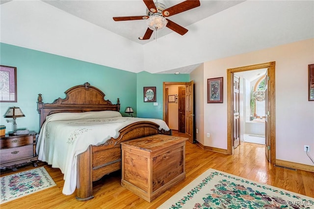 716 W Riverside Dr, Lanexa, VA 23089 - bedroom with light wood-style floors, vaulted ceiling, connected bathroom, and a ceiling fan