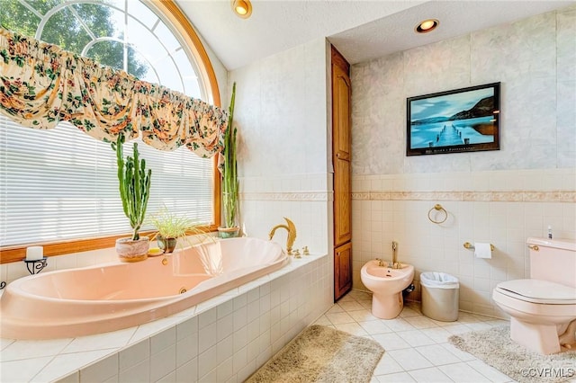 716 W Riverside Dr, Lanexa, VA 23089 - bathroom featuring a whirlpool tub, tile walls, tile patterned floors, a bidet, and vaulted ceiling