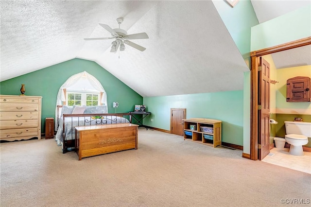 716 W Riverside Dr, Lanexa, VA 23089 - carpeted bedroom with lofted ceiling, ensuite bath, a textured ceiling, and a ceiling fan