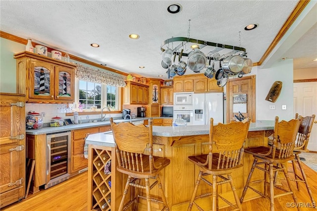 716 W Riverside Dr, Lanexa, VA 23089 - kitchen featuring wine cooler, white appliances, light wood-type flooring, light countertops, and a textured ceiling
