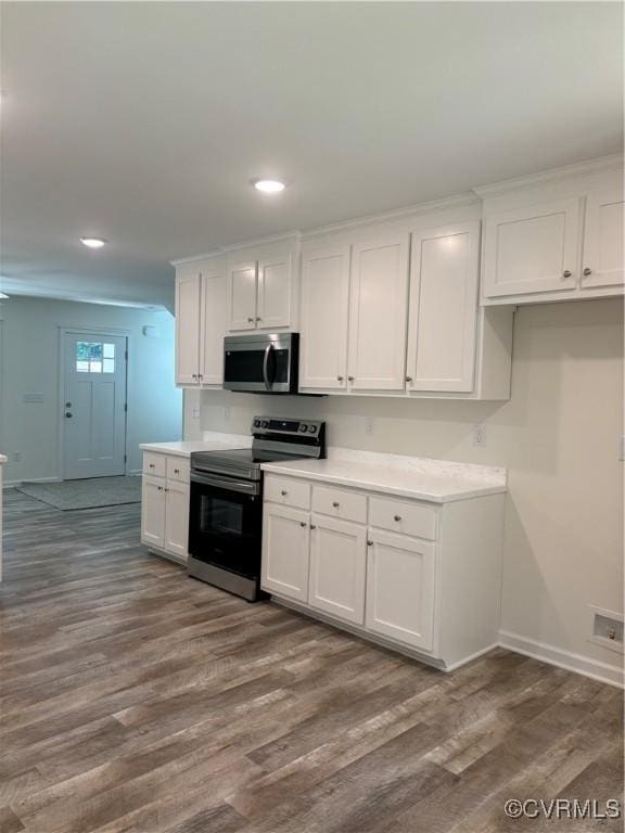 4006 Chesdin Blvd, Sutherland, VA 23885 - kitchen with stainless steel appliances, white cabinetry, dark wood-style flooring, recessed lighting, and light countertops