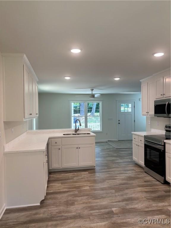 4006 Chesdin Blvd, Sutherland, VA 23885 - kitchen with stainless steel appliances, dark wood-type flooring, a peninsula, white cabinetry, and recessed lighting