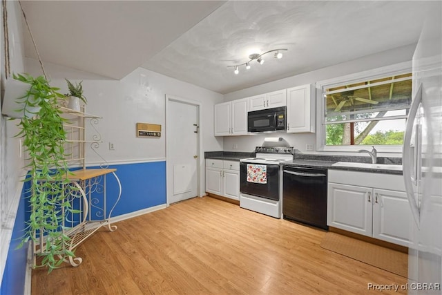 16 Diggs Dr, Hampton, VA 23666 - kitchen with black appliances, dark countertops, light wood-type flooring, and white cabinetry