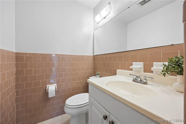 16 Diggs Dr, Hampton, VA 23666 - bathroom featuring tile walls, vanity, wainscoting, and tile patterned floors