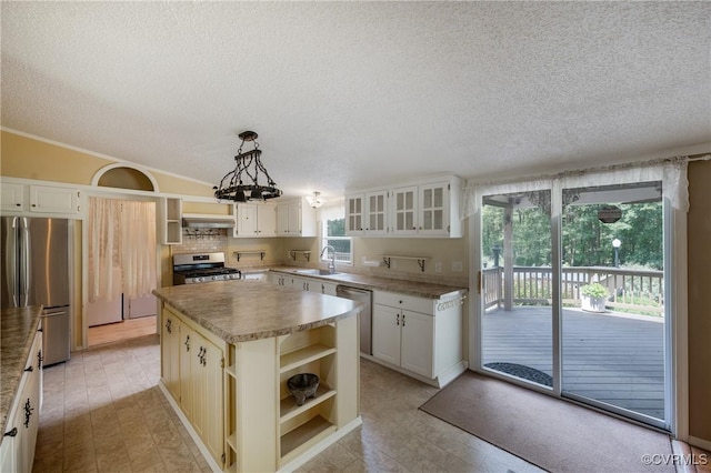 454 Elam Forest Dr, Prospect, VA 23960 - kitchen featuring open shelves, stainless steel appliances, a textured ceiling, a center island, and glass insert cabinets