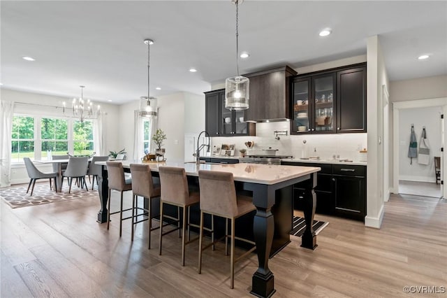 TBD Cedar Lane, Glen Allen, VA 23059 - kitchen featuring light countertops, a breakfast bar, light wood finished floors, a center island with sink, and recessed lighting