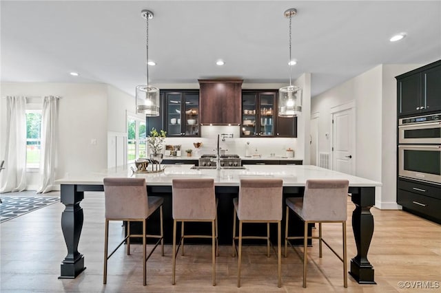 TBD Cedar Lane, Glen Allen, VA 23059 - kitchen with custom exhaust hood, light countertops, plenty of natural light, glass insert cabinets, and recessed lighting