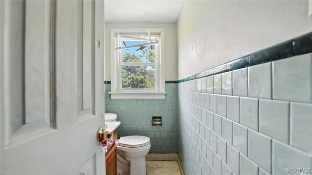 17 E 31st St, Richmond, VA 23224 - bathroom with tile walls, vanity, and wainscoting