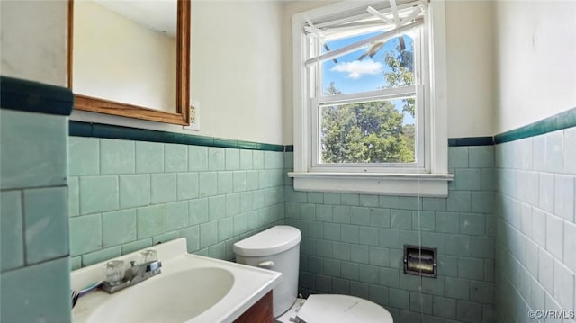 17 E 31st St, Richmond, VA 23224 - bathroom with tile walls, healthy amount of natural light, wainscoting, and vanity