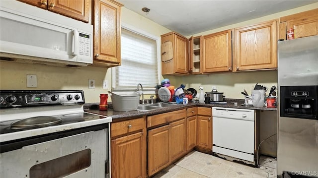 17 E 31st St, Richmond, VA 23224 - kitchen featuring white appliances, dark countertops, and brown cabinets