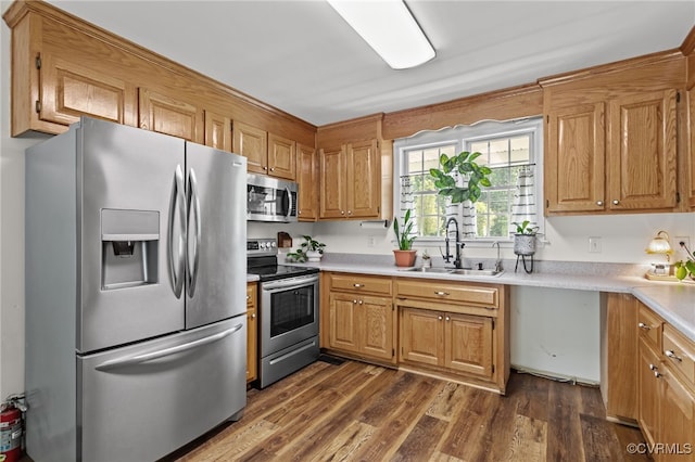 11501 Courthouse Rd, Dinwiddie, VA 23841 - kitchen featuring stainless steel appliances, light countertops, dark wood-type flooring, and brown cabinetry