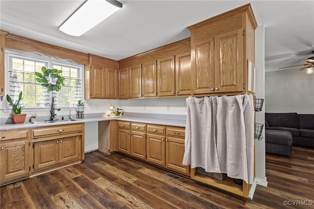 11501 Courthouse Rd, Dinwiddie, VA 23841 - kitchen featuring light countertops, dark wood-type flooring, a ceiling fan, and brown cabinetry