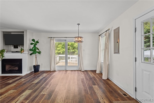 11501 Courthouse Rd, Dinwiddie, VA 23841 - unfurnished dining area featuring dark wood-style floors, plenty of natural light, a fireplace, and a chandelier