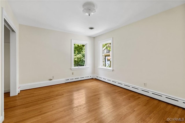 7800 Wood Rd, Henrico, VA 23229 - unfurnished bedroom with light wood-type flooring and a baseboard heating unit