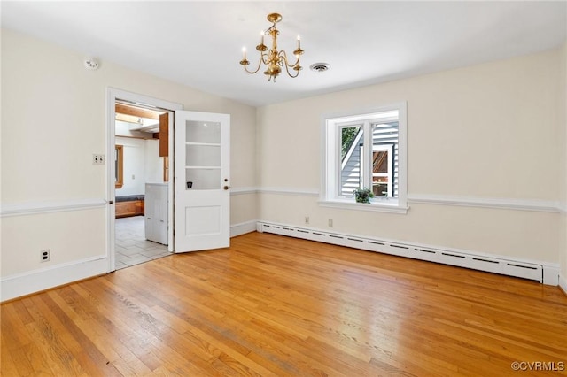 7800 Wood Rd, Henrico, VA 23229 - empty room with a baseboard heating unit, a chandelier, light wood-style floors, and a smoke detector