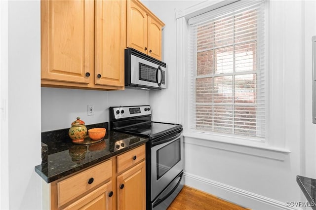 603 N Allen Ave Unit U1B, Richmond, VA 23220 - kitchen featuring stainless steel appliances, light brown cabinets, dark stone counters, and light wood finished floors