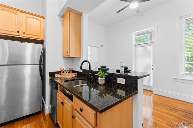 603 N Allen Ave Unit U1B, Richmond, VA 23220 - kitchen featuring appliances with stainless steel finishes, a peninsula, wood finished floors, light brown cabinetry, and dark stone counters