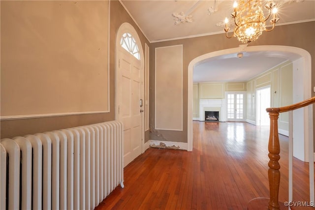 1602 Brandon Ave, Petersburg, VA 23805 - foyer entrance with radiator heating unit, arched walkways, crown molding, hardwood / wood-style floors, and a chandelier