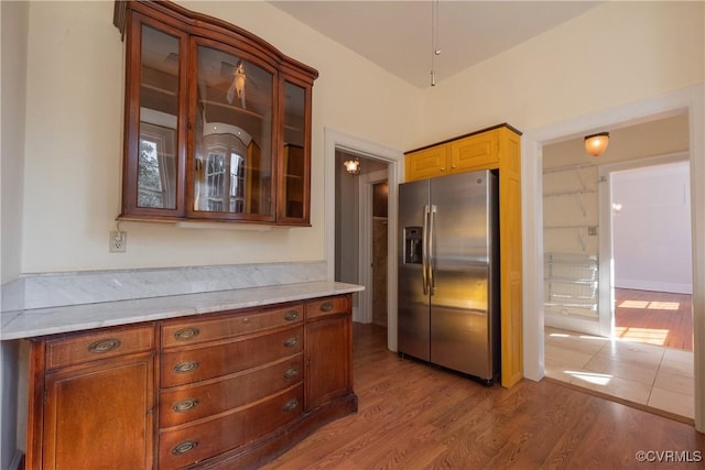 1602 Brandon Ave, Petersburg, VA 23805 - kitchen with stainless steel refrigerator with ice dispenser, light countertops, wood finished floors, and glass insert cabinets