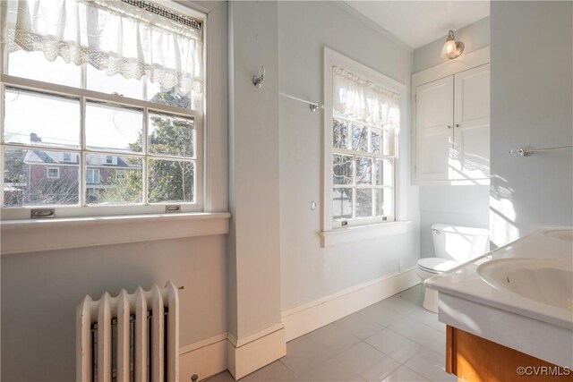 1602 Brandon Ave, Petersburg, VA 23805 - bathroom with radiator heating unit, plenty of natural light, and vanity