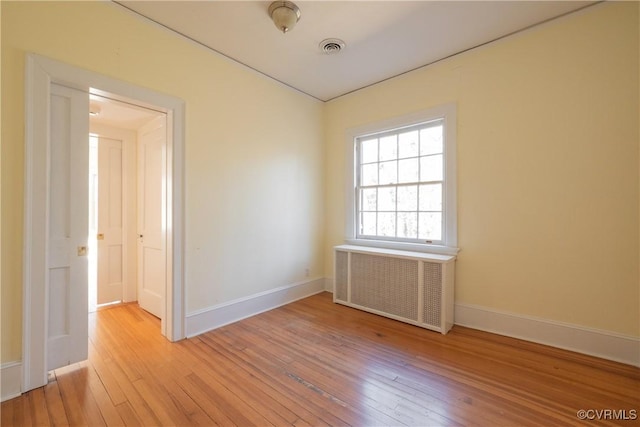 1602 Brandon Ave, Petersburg, VA 23805 - empty room with radiator and light wood finished floors